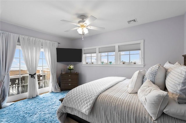 bedroom with access to outside, ceiling fan, and french doors