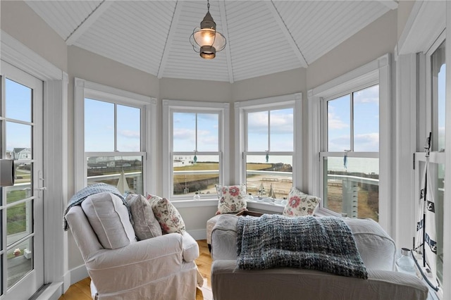 sunroom with plenty of natural light, wood ceiling, and lofted ceiling