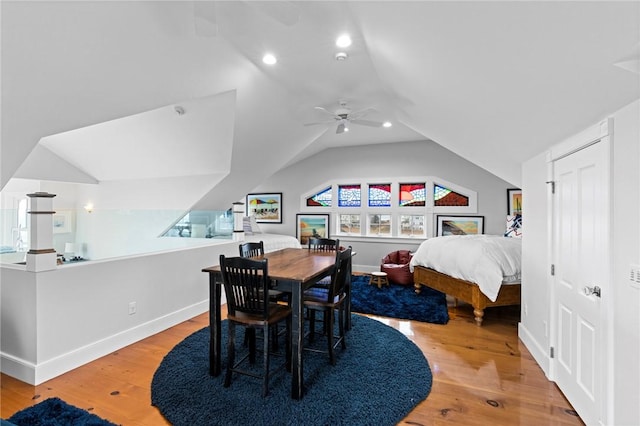 dining room featuring lofted ceiling, ceiling fan, and wood-type flooring