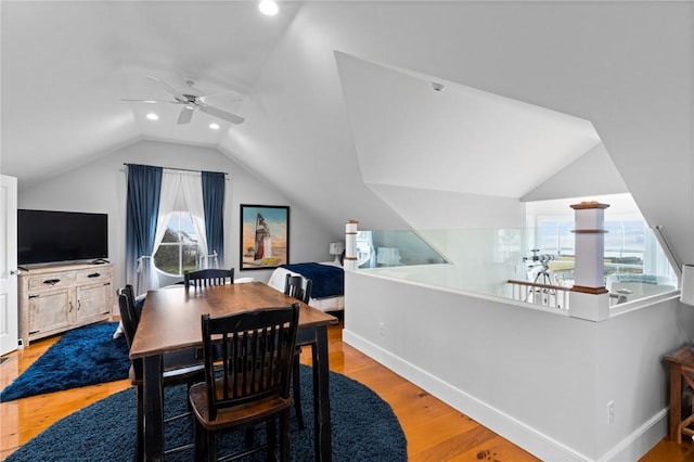 dining area featuring light wood-type flooring, vaulted ceiling, plenty of natural light, and ceiling fan