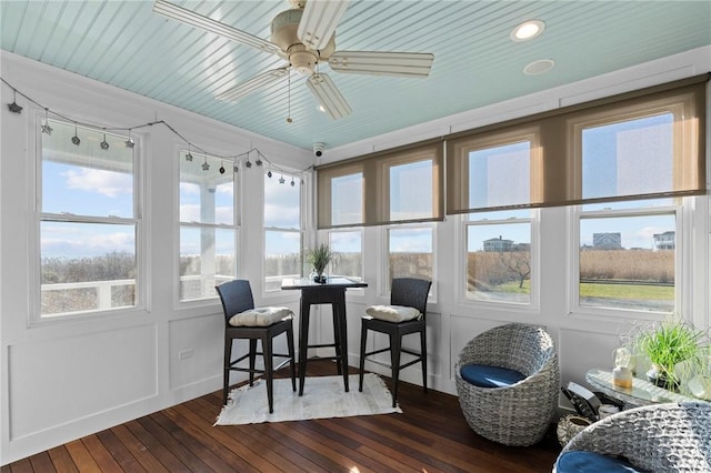 sunroom featuring a wealth of natural light and ceiling fan