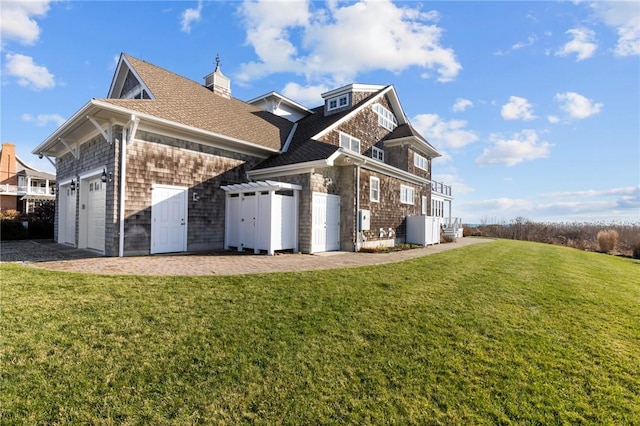 view of home's exterior with a yard and a garage