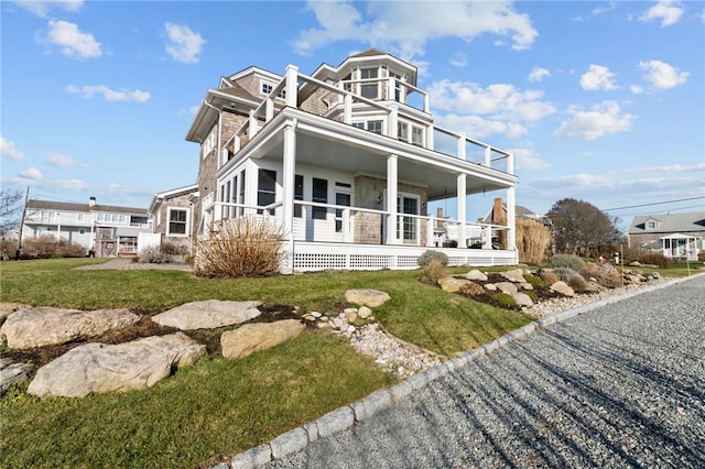 view of front of property with a front yard and covered porch