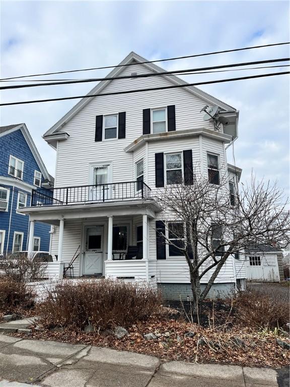 view of front of home featuring a balcony and covered porch