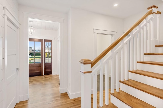 foyer entrance featuring a chandelier and light hardwood / wood-style floors