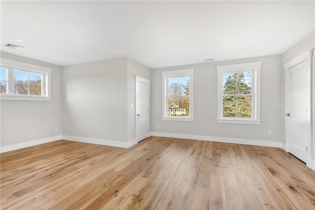 spare room featuring light hardwood / wood-style floors