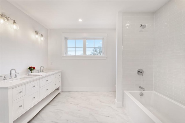 bathroom with vanity and tiled shower / bath