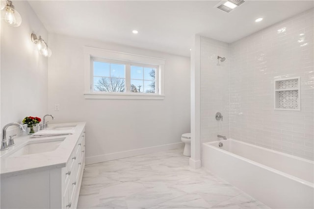 full bathroom featuring vanity, toilet, and tiled shower / bath combo