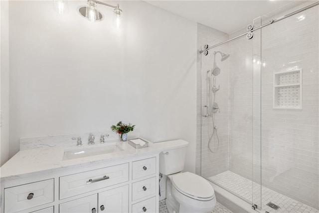 bathroom with walk in shower, vanity, and toilet