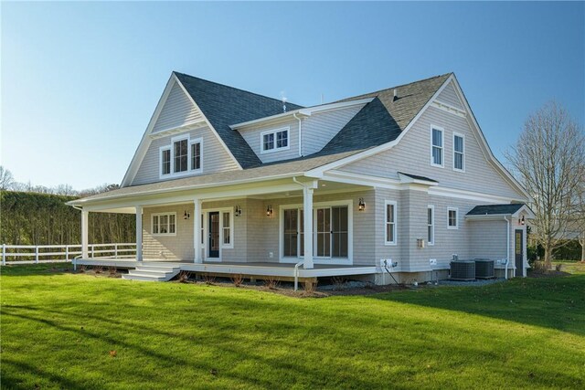 view of front of house featuring a porch, a front lawn, and cooling unit