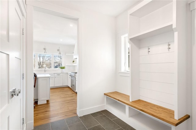 mudroom with dark tile patterned flooring