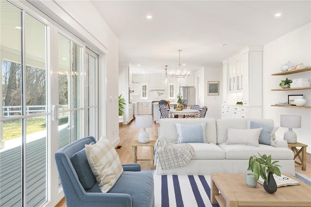 living room featuring a chandelier and light hardwood / wood-style flooring