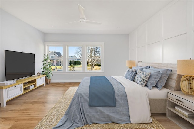 bedroom with ceiling fan and light hardwood / wood-style flooring