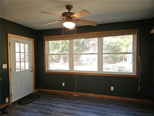 interior space with ceiling fan and dark hardwood / wood-style flooring