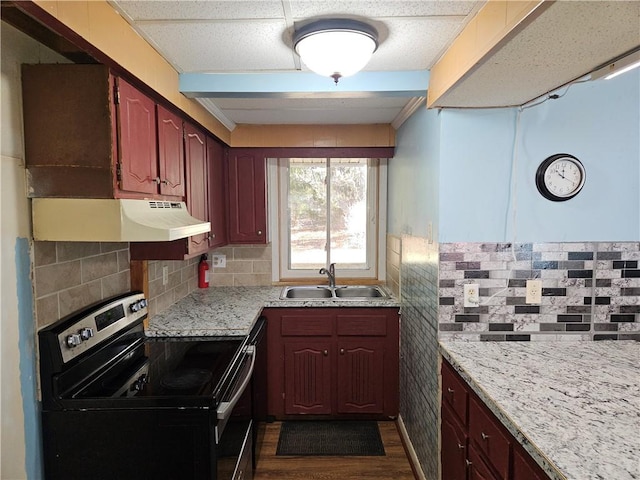 kitchen featuring backsplash, stainless steel range with electric cooktop, dark wood-type flooring, sink, and light stone countertops