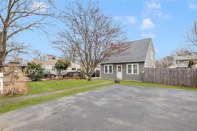 cape cod home with a front yard