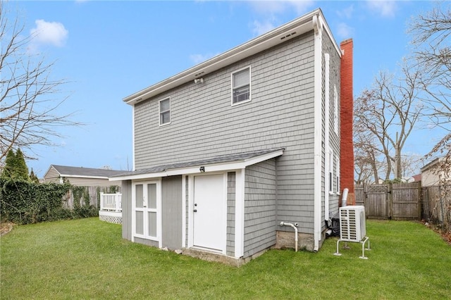 back of property featuring a yard and a deck