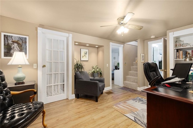 office area with light hardwood / wood-style flooring and ceiling fan