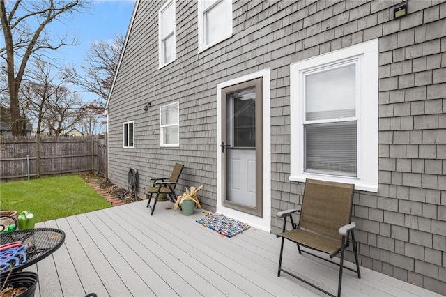 wooden terrace with a lawn