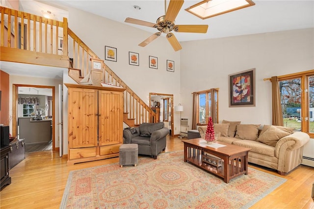 living room featuring light wood-type flooring, a wealth of natural light, and ceiling fan