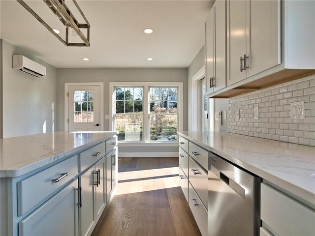 kitchen with light stone countertops, tasteful backsplash, dishwasher, white cabinetry, and a wall unit AC