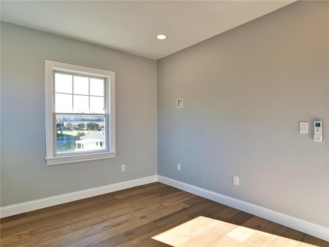 empty room with dark wood-type flooring