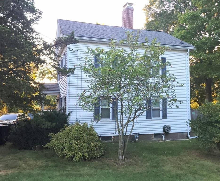 view of property exterior with a yard