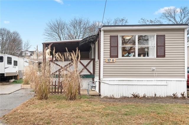 view of side of home with a yard