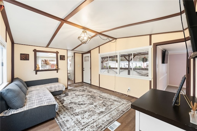 living room with vaulted ceiling with beams, wood-type flooring, and a notable chandelier