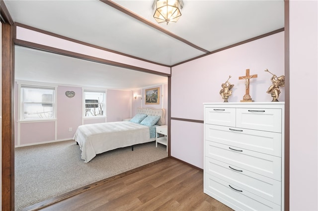 bedroom featuring light wood-type flooring and crown molding