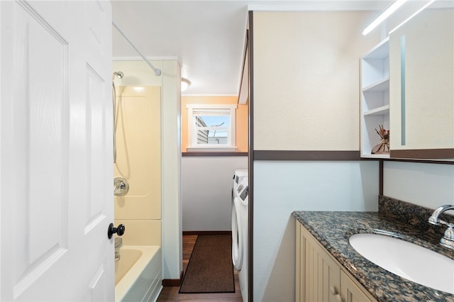 bathroom with vanity, washer / clothes dryer, hardwood / wood-style flooring, and tub / shower combination