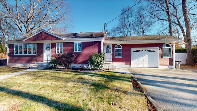 ranch-style house with a garage and a front lawn