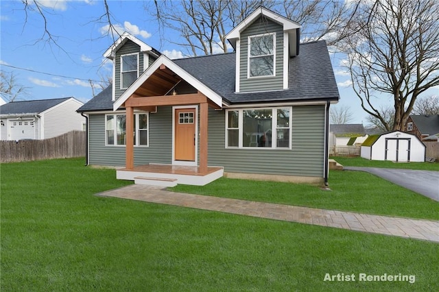 cape cod house featuring a front lawn and a shed