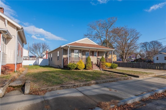 bungalow-style home with a front lawn and a porch