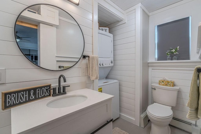 bathroom with vanity, toilet, wooden walls, and a baseboard radiator