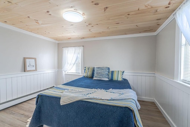 bedroom featuring hardwood / wood-style floors, wooden ceiling, crown molding, and multiple windows