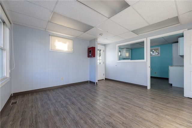 interior space with dark hardwood / wood-style flooring and a paneled ceiling