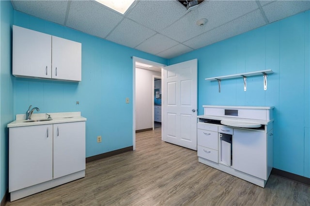 laundry room with light hardwood / wood-style flooring and sink