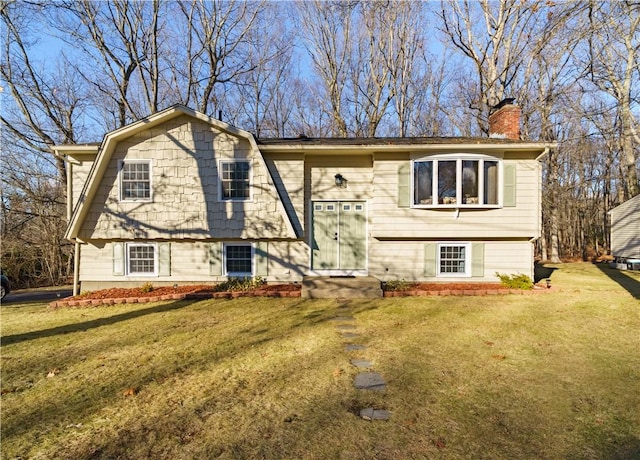 raised ranch featuring a front lawn