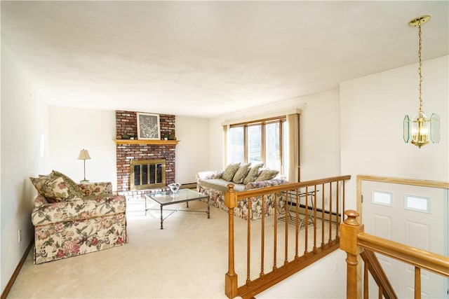 living room featuring carpet flooring, a notable chandelier, baseboard heating, and a fireplace