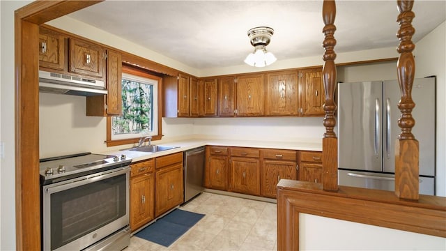 kitchen featuring appliances with stainless steel finishes, sink, and range hood