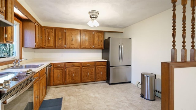 kitchen with ventilation hood, sink, stainless steel appliances, and a baseboard radiator