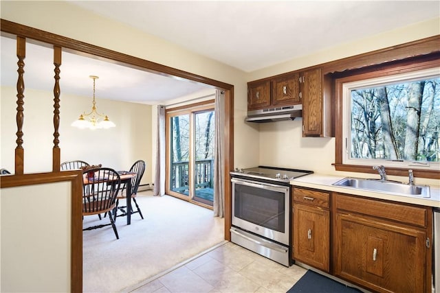 kitchen with appliances with stainless steel finishes, decorative light fixtures, plenty of natural light, and sink