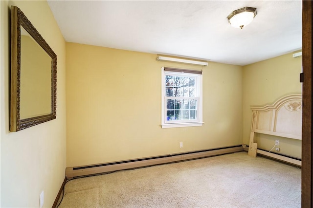 unfurnished bedroom with carpet and a baseboard heating unit