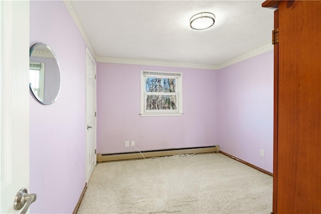 unfurnished room with baseboard heating, light carpet, and crown molding