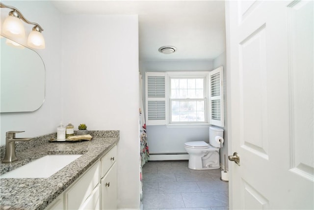 bathroom with baseboard heating, tile patterned floors, vanity, and toilet