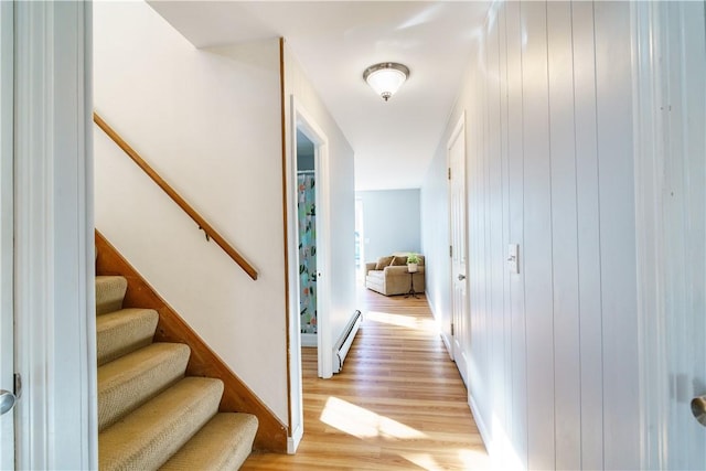 hall featuring light hardwood / wood-style floors and a baseboard heating unit