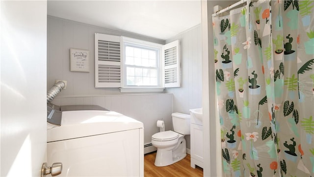 bathroom featuring hardwood / wood-style floors, toilet, a shower with shower curtain, and a baseboard heating unit