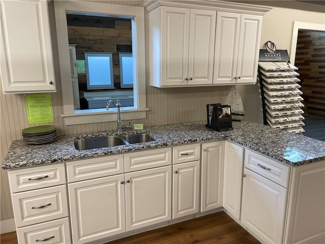 kitchen featuring white cabinetry and sink