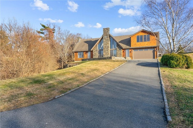 view of front of house featuring a garage and a front lawn